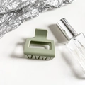 Close-up of matte sage green square hair claw clip on minimalist aesthetic background - Fruit Green
