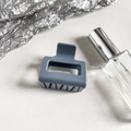 Detail shot of a dusty blue square hair claw clip on a clean modern aesthetic background - Blue Grey