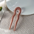 Detailed view of matte coral red U-shaped hairpin with wavy double prong structure - Matte Orange
