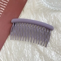 Detail view of purple matte finish hair comb with 15-teeth design on textured background - 9cm Matte Purple