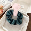 Detailed close-up of dark green velvet scrunchie in premium LOBABA brand packaging - Dark Green