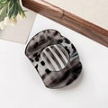 Flat round hair claw clip in translucent grey tortoiseshell finish with hollow stripes - Glossy Gray Leopard