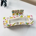 Detailed view of large white hair claw clip with colorful heart prints and text - 8.5cm Heart Print - Style K White Base / PS