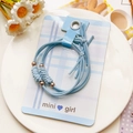 Detail of light blue bow hair ties with gold beads on display card accessory set - Wheat Spike Pattern Style - Blue
