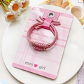 Detail of pink bow hair ties with gold beads on display card against white porcelain - Wheat Spike Pattern Style - Pink
