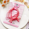 Détail d'élastiques à cheveux roses à nœud sur carte avec touches florales - Style Nœud en 8 Dégradé - Rose