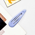 Detailed macro view of a matte lavender purple teardrop metal hair clip on a textured surface - Alloy / Blue Purple