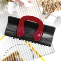 Close-up of contrast color hair claw clip with black base and red U-shaped design - Square Bag - Black