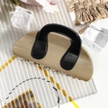 Detail of khaki and black contrast hair claw clip on a stylish textured glass surface - Semicircle Bag - Milk Coffee