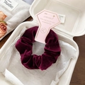 Deep red velvet hair scrunchie with soft elastic texture on elegant packaging card - Burgundy
