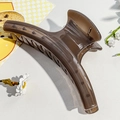 Detailed view of large translucent amber resin hair claw clip with sturdy metal spring - 14.5cm / Glossy Bean Paste Pink