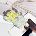 Detail der transparenten Haarspange mit gelber Blume und weißen Gänseblümchen-Einsätzen - Gelb