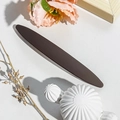 Detail shot of a dark brown oval spring hair clip on a textured white surface background - 11.5cm Long Oval / Matte Dark Coffee