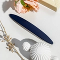 Detailed view of matte navy blue spring hair clip on a minimalist textured surface - 11.5cm Long Oval / Matte Royal Blue