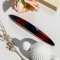 Detailed view of glossy gradient red acetate spring hair clip on decorative background - 11.5cm Long Oval / Shiny Tortoise Shell