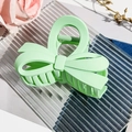 Detailed macro view of mint green matte bow hair claw clip with strong metal spring - Matte Fruit Green