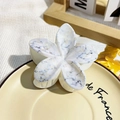 Elegant frangipani hair claw with white marble resin texture for stylish updos - Ivory Ink Style