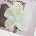 Close-up of blue and white floral hair claw clip with acrylic petals on paper background - Beige with Blue Band