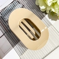 Macro detail of large cream beige oval hair claw clip with glossy resin finish - Glossy Light Coffee