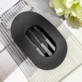 Macro detail of matte black oval hair claw with hollow design on textured acrylic - Matte Black