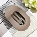 Detail view of a large matte mocha oval hair claw clip on a textured glass surface - Matte Dark Brown