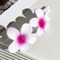 Detail view of sweet gradient flower hair clip with white petals and pink center accents - White Pink