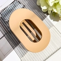 Macro shot of large matte apricot oval hair claw clip with strong grip design - Matte Ginger