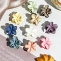 Flat lay of colorful 2.5cm matte plumeria flower hair claws in various pastel shades - 2.5cm Frangipani - Matte Morandi (Bagged)