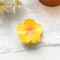Detailed top view of a yellow plumeria flower hair claw clip on a white art paper background - 4cm Hibiscus Claw Clip - Gradient Yellow
