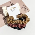 Close-up of three satin scrunchies in gold, red, and black on a decorative card - Black/Coffee/Bronze