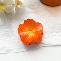 Detailed top view of a glossy orange plumeria flower hair claw clip on white background - 4cm Hibiscus Claw Clip - Gradient Orange