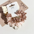 Close-up of three satin scrunchies in bronze, champagne, and white on a display card - Pink/Light Green/Beige