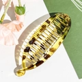 Macro detail of amber leopard print banana hair clip showing fine teeth and acrylic texture - Plastic/Resin / 11.5cm / Glossy Light Leopard