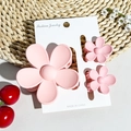 Detailed view of matte pink flower hair claw clips set on display card with rural decor - Matte Pink