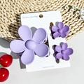Detailed view of matte lavender flower hair claws set of three on a white display card - Matte Lavender
