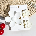 Three-piece set of matte floral hair claws in white and cream shown on display card - Matte Cream White
