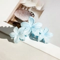 Set of two light blue marble-textured plumeria hair claws with pearlescent resin finish - Light Blue