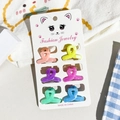 Detailed view of six colorful mini resin hair claws on a cute cat display card - Small / Marble Cross Shape Style