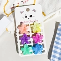 Set of six colorful flower-shaped mini hair claws on a fashion jewelry display card - Small / Marble Frangipani Style