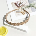 Detail of matte khaki daisy headband showing non-slip teeth and floral resin design - Matte Floral Headband - Light Coffee
