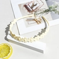Detail view of cream yellow matte daisy hairband with a non-slip wavy floral structure - Matte Floral Headband - Off-white