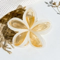 Detail view of amber and cream plumeria flower hair claw clip with acetate finish - Orange Cream Edge