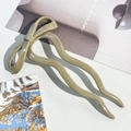 Close-up of a glossy khaki U-shaped hair pin featuring a stylish bow design detail - 12cm Bow Hair Stick Glossy Milk Coffee