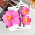 Close-up of pink frangipani flower hair clips set on a white display card - Hibiscus Triple Clip Set - Gradient Pink