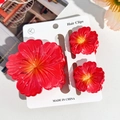 Three-piece set of red hibiscus flower hair clips on display card with macro details - Hibiscus Triple Clip Set - Gradient Red