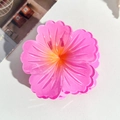 Detailed view of a translucent bright pink hibiscus hair claw with yellow center - 7.5cm Hibiscus Claw Clip - Gradient Pink