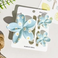 Three-piece light blue hair clip set with white daisy prints on display card - Light Blue White Daisy Style (UV Printed Frangipani 3-Piece Set - ABS-103-4)