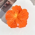 Macro detail of a bright orange translucent flower hair claw clip with a glossy finish - 7.5cm Hibiscus Claw Clip - Gradient Orange