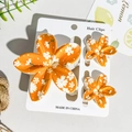 Detailed set of orange floral hair clips with white daisy print and matte plastic finish - Orange Base White Daisy Style (UV Printed Plumeria 3-Piece Set-ABS-103-5)