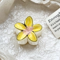 Detail view of the yellow floral claw clip with hand-painted outlines on a textured background - Yellow Pink Cartoon Hand-drawn Style (110-B2)